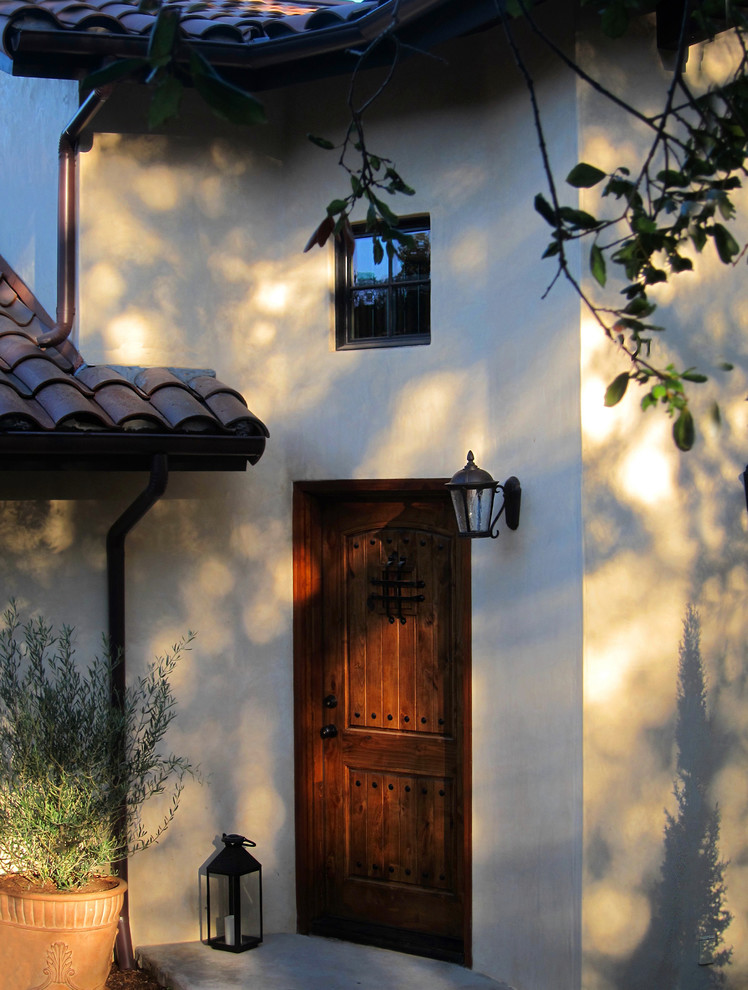 Mittelgroßes, Zweistöckiges Mediterranes Einfamilienhaus mit Putzfassade, beiger Fassadenfarbe, Satteldach und Ziegeldach in Santa Barbara