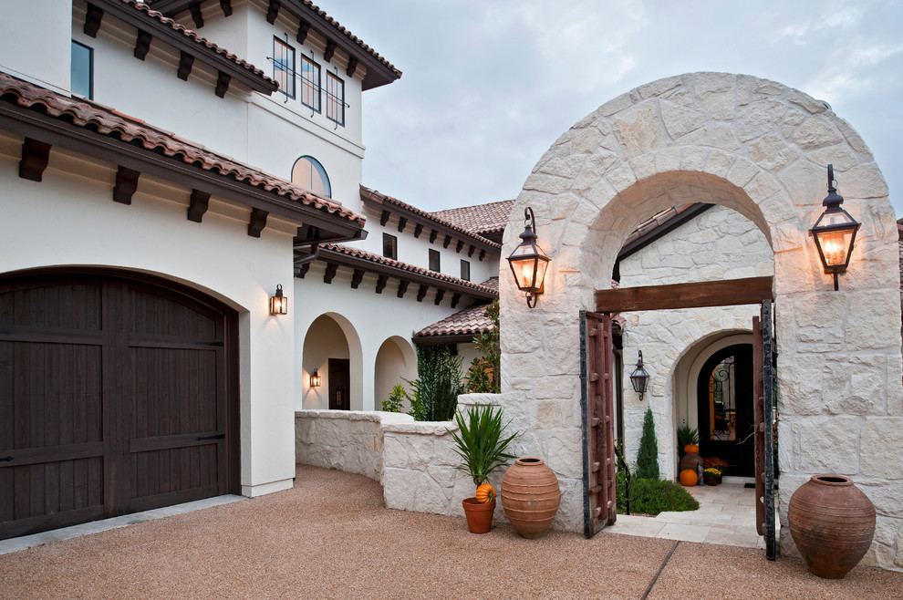 Inspiration for a huge mediterranean white two-story stucco exterior home remodel in Austin
