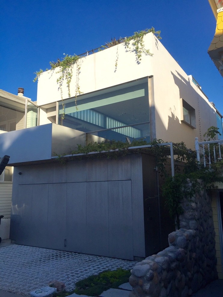 This is an example of a small and white contemporary two floor house exterior in Los Angeles with metal cladding.