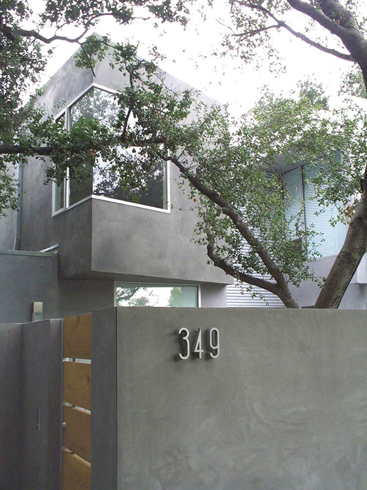 Inspiration for a mid-sized contemporary gray two-story stucco exterior home remodel in Los Angeles
