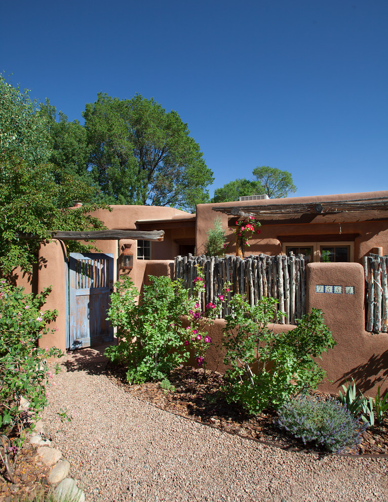 Large and brown bungalow clay house exterior in Albuquerque with a flat roof.