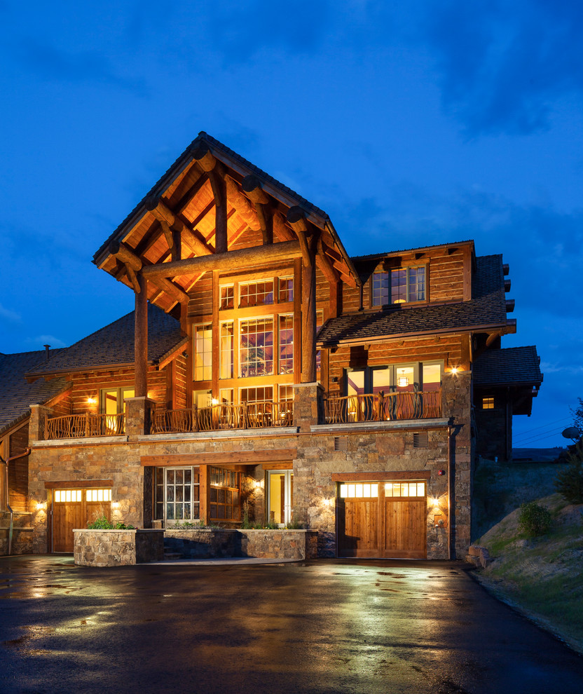 Rustic three-story wood exterior home idea in Other