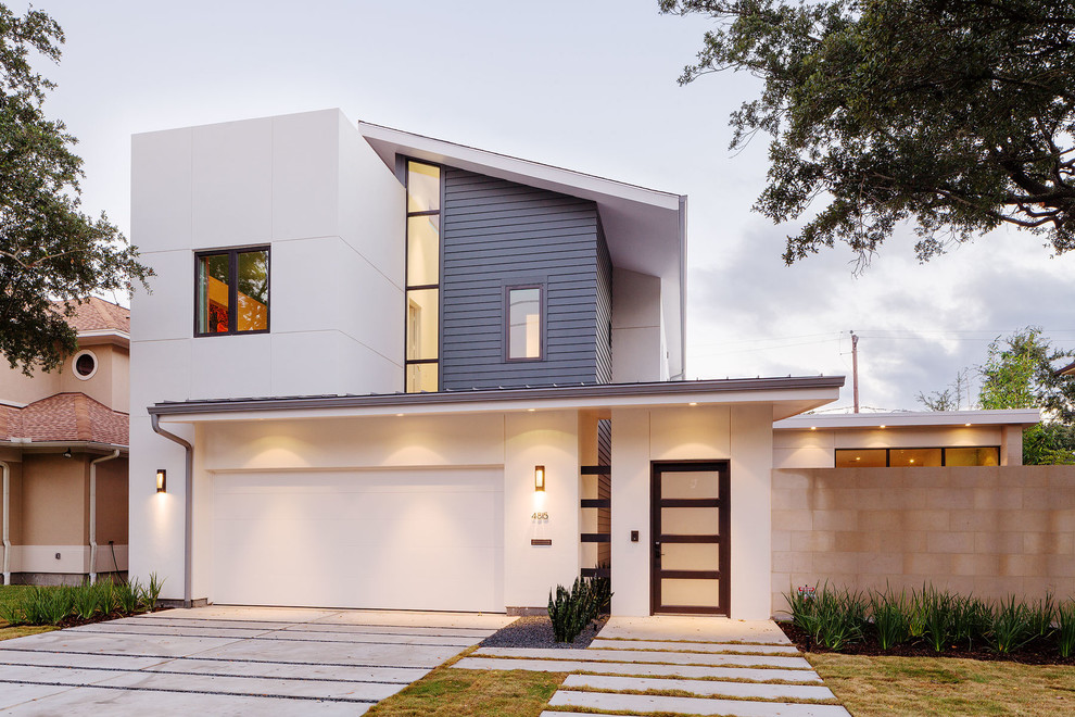 Design ideas for a white contemporary two floor house exterior in Houston with mixed cladding.