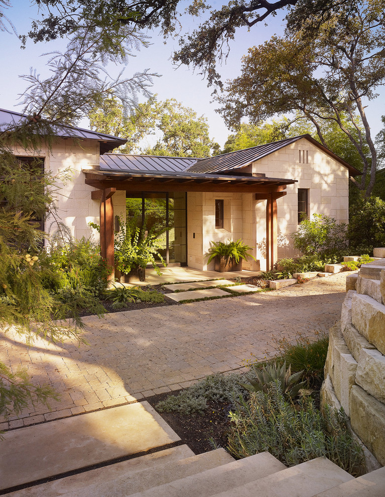 Design ideas for a contemporary house exterior in Austin with stone cladding.