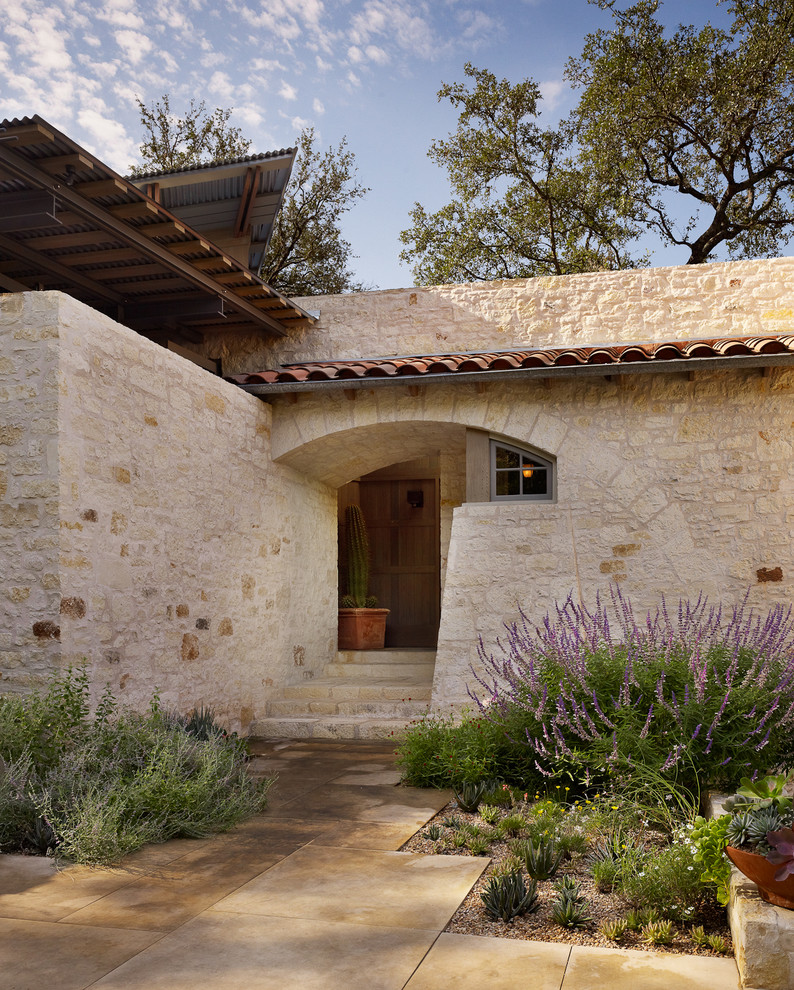 Inspiration for a mediterranean stone exterior home remodel in Austin