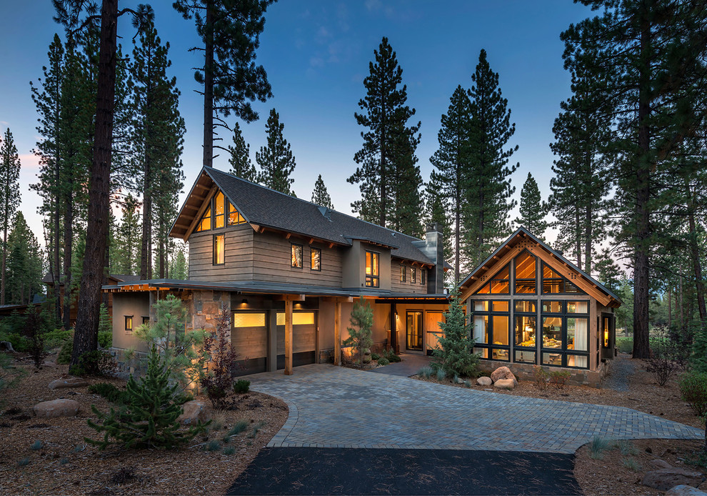 This is an example of a rustic two floor house exterior in Sacramento with wood cladding and a pitched roof.