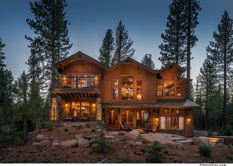 Large elegant brown two-story wood exterior home photo in Sacramento
