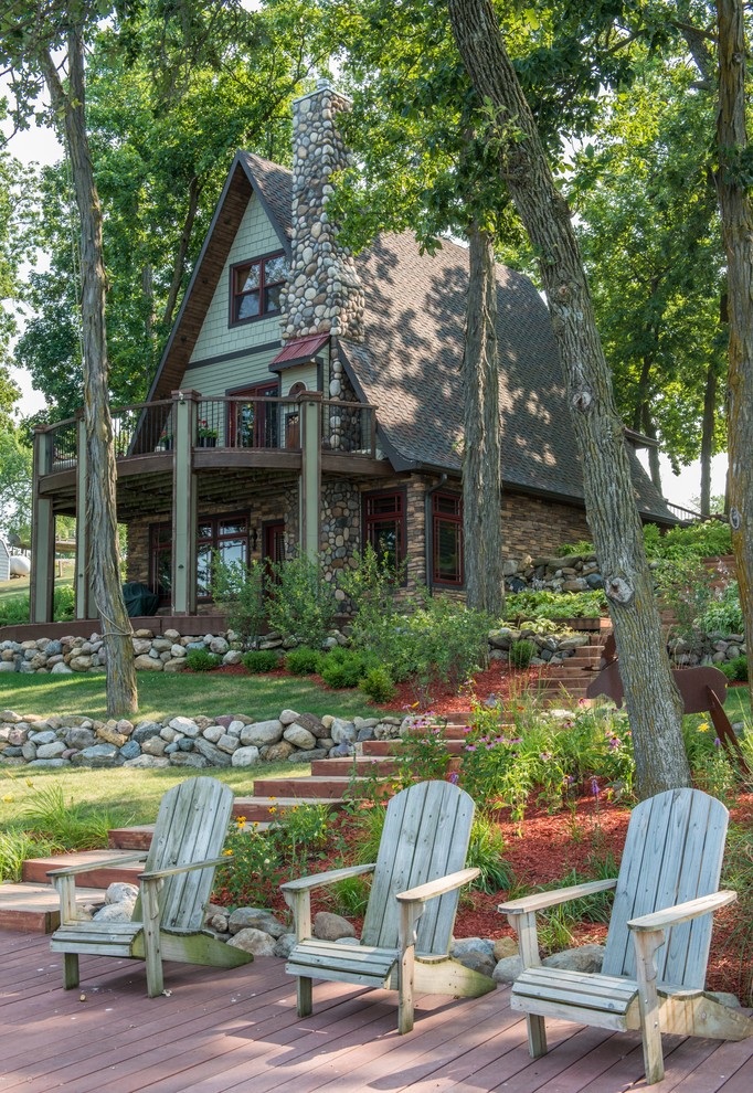 Mid-sized elegant green three-story mixed siding gable roof photo in Other
