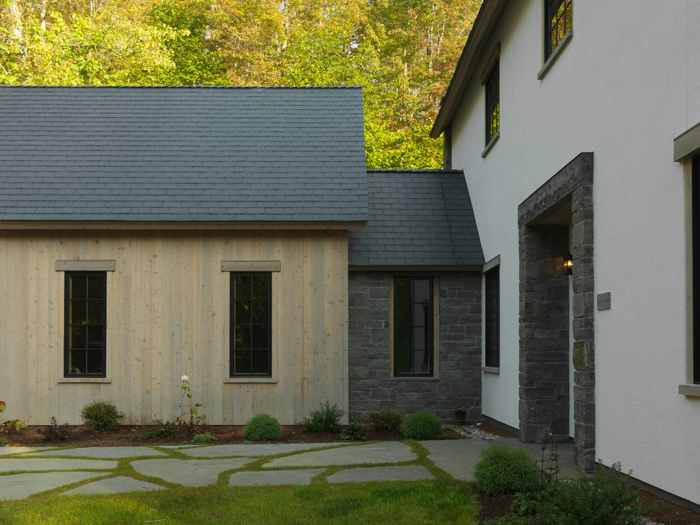Example of a farmhouse exterior home design in Burlington