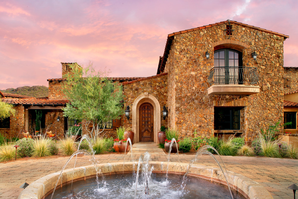 Inspiration for a mediterranean stone exterior home remodel in Phoenix