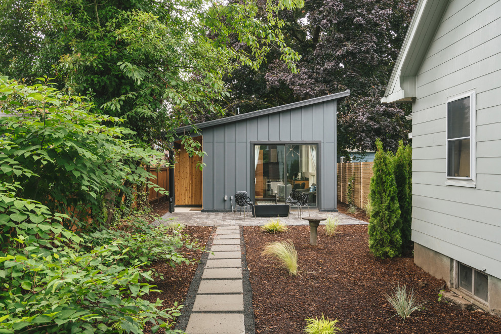 Inspiration for a small and gey modern bungalow detached house in Portland with wood cladding, a lean-to roof and a metal roof.