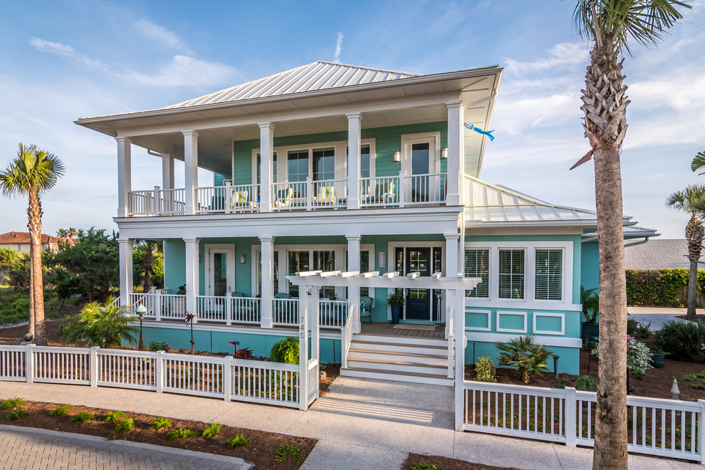 Inspiration for a mid-sized coastal blue two-story wood house exterior remodel in Jacksonville with a hip roof and a metal roof