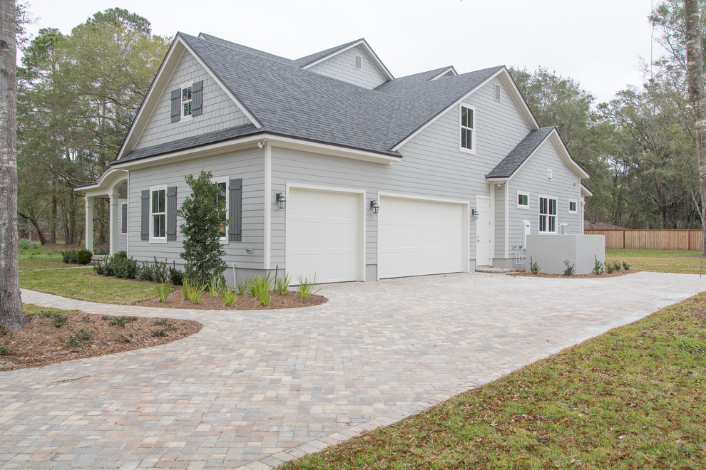 Example of a classic two-story concrete fiberboard gable roof design in Jacksonville with a mixed material roof