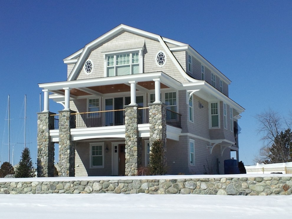 Mid-sized beach style beige three-story wood house exterior photo in Bridgeport with a gambrel roof and a tile roof