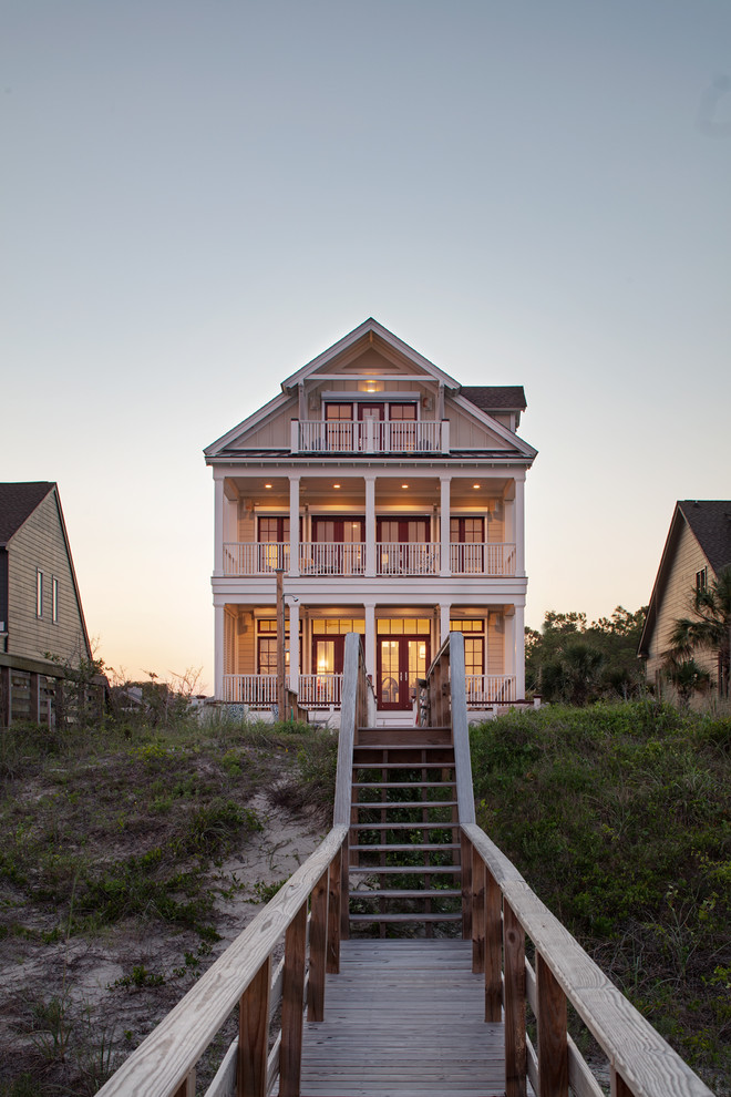 Inspiration for a mid-sized coastal beige three-story concrete fiberboard exterior home remodel in Charleston with a shingle roof
