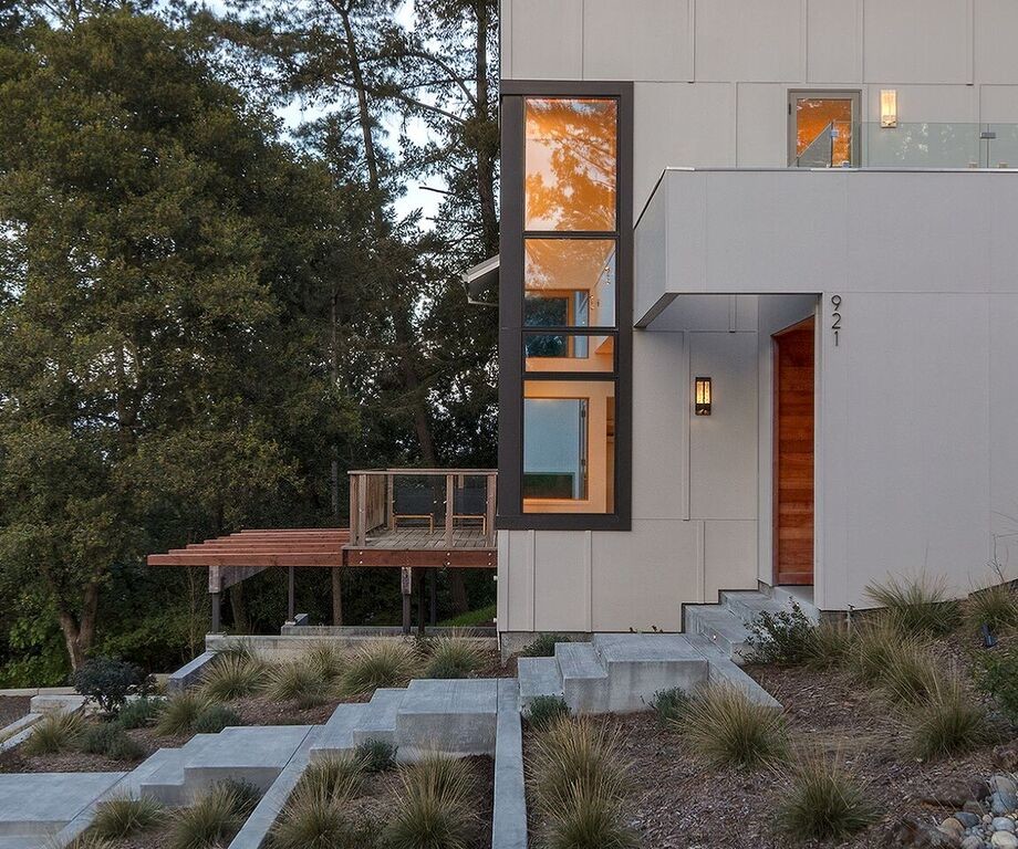 Inspiration for a mid-sized contemporary gray two-story concrete fiberboard house exterior remodel in San Francisco with a shed roof and a shingle roof