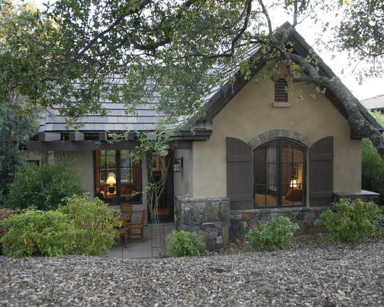 Design ideas for a large and gey rustic bungalow house exterior in Sacramento with stone cladding.