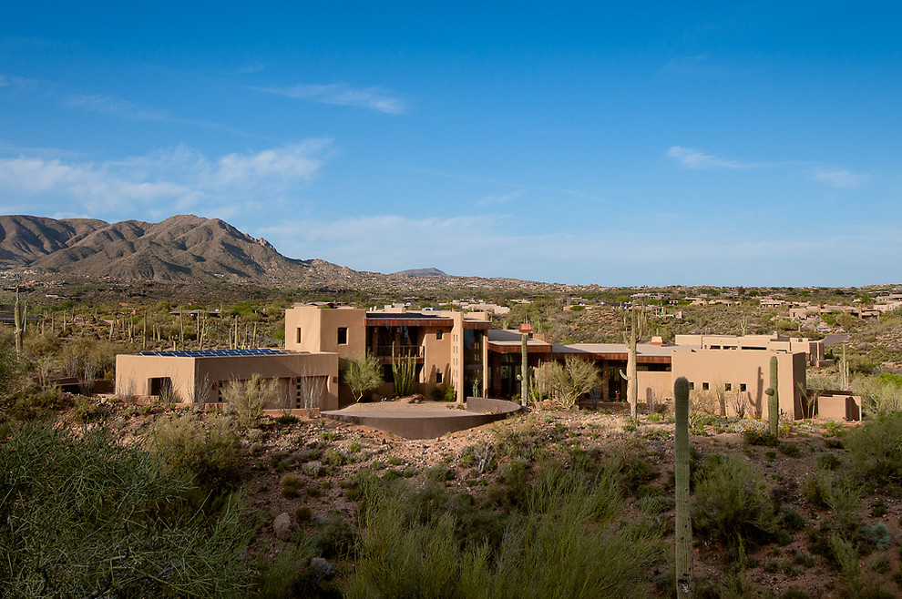Inspiration for a huge southwestern two-story exterior home remodel in Phoenix