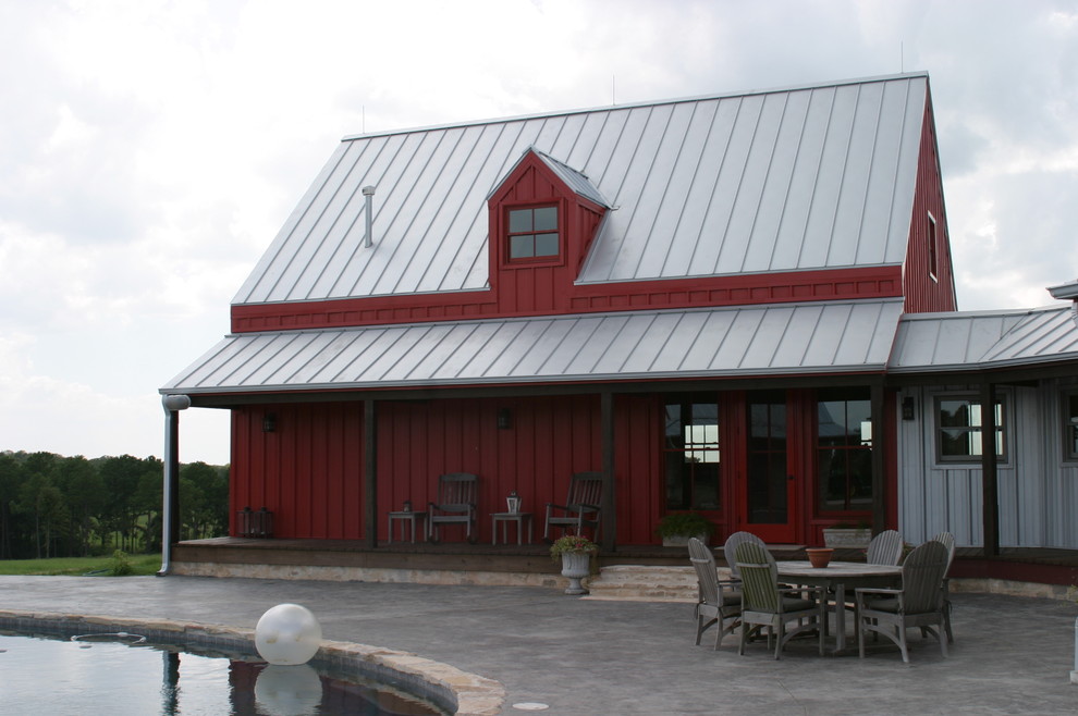 Ispirazione per la villa ampia rossa country a due piani con rivestimento con lastre in cemento, tetto a capanna e copertura in metallo o lamiera