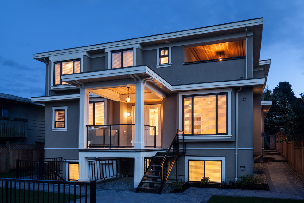 Large and blue classic house exterior in Vancouver with three floors and concrete fibreboard cladding.