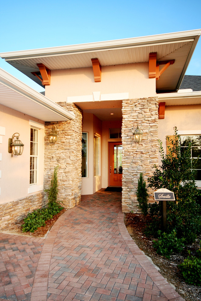 Inspiration for a mid-sized mediterranean beige one-story stucco exterior home remodel in Orlando