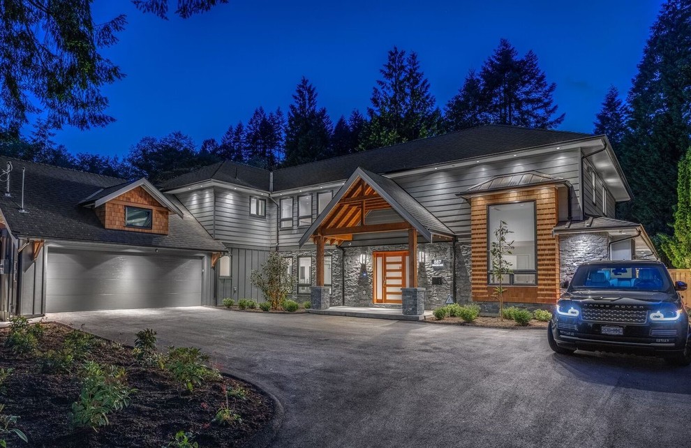 Huge craftsman gray two-story mixed siding house exterior idea in Vancouver with a hip roof and a shingle roof