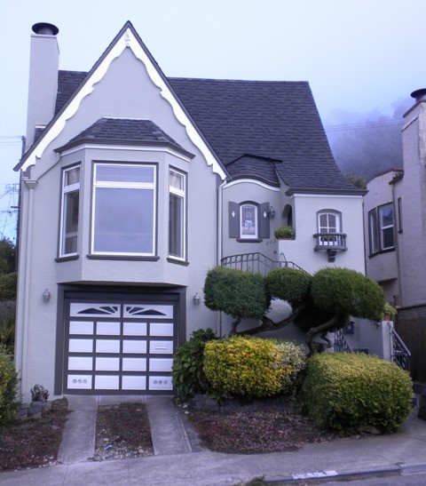 Medium sized and green classic two floor house exterior in San Francisco with wood cladding and a pitched roof.