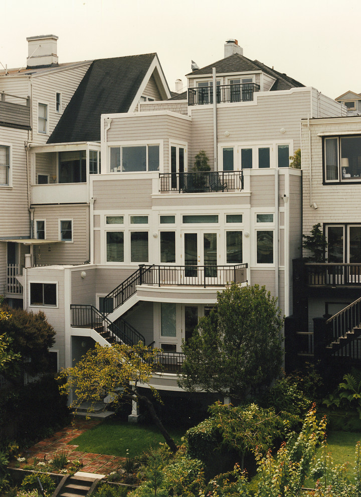 Inspiration for a large and beige classic terraced house in San Francisco with three floors, vinyl cladding and a mansard roof.