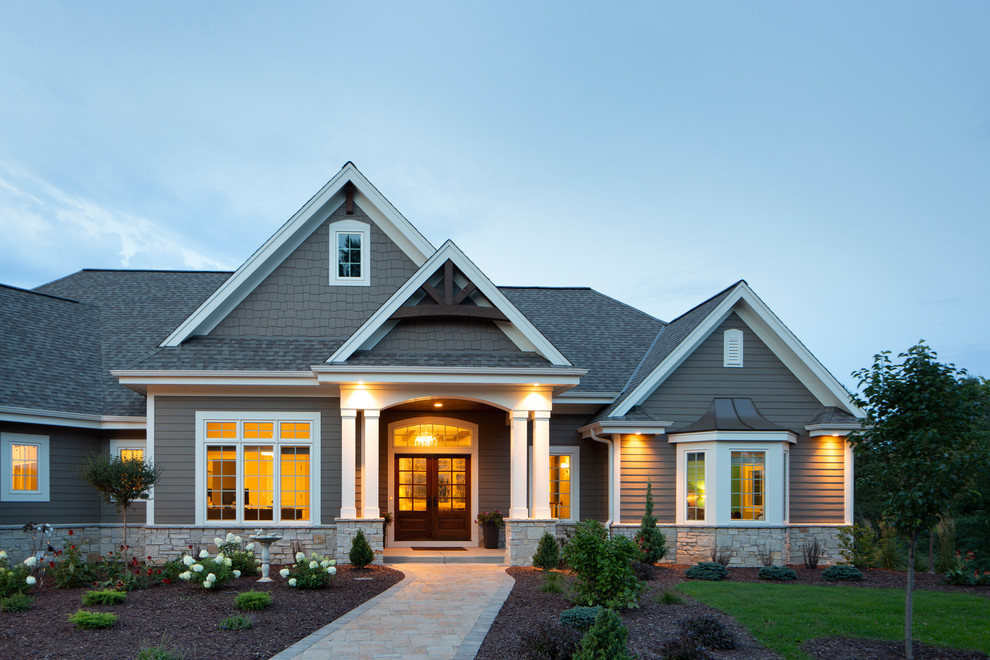 Diseño de fachada de casa marrón de estilo americano grande de una planta con revestimientos combinados y tejado de varios materiales