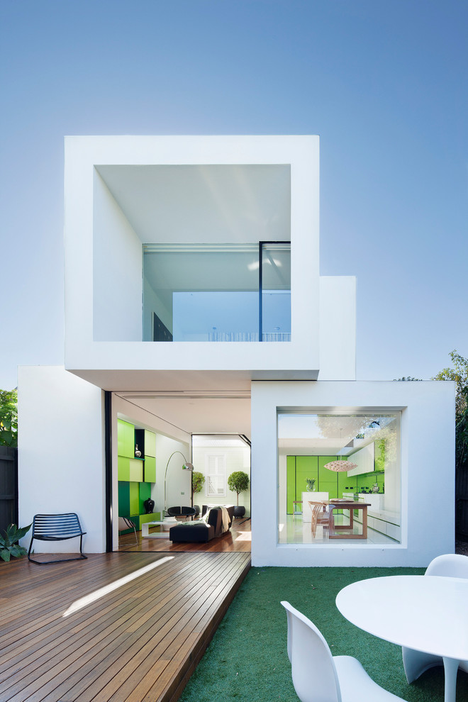Cette photo montre une façade de maison blanche tendance de taille moyenne et à un étage avec un toit plat.