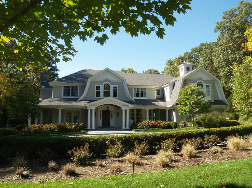 Inspiration for a timeless gray two-story wood exterior home remodel in New York with a gambrel roof