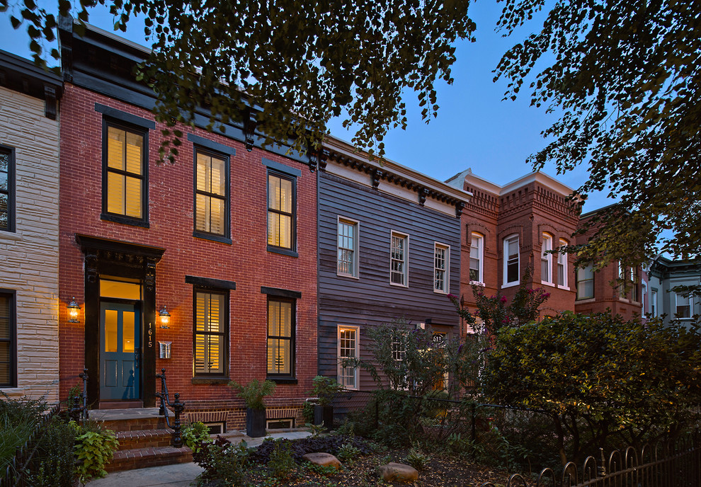 Example of a mid-sized transitional red two-story brick flat roof design in DC Metro