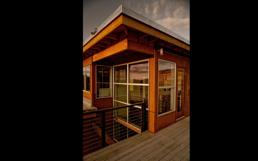 Design ideas for a red industrial two floor house exterior in Seattle with metal cladding.