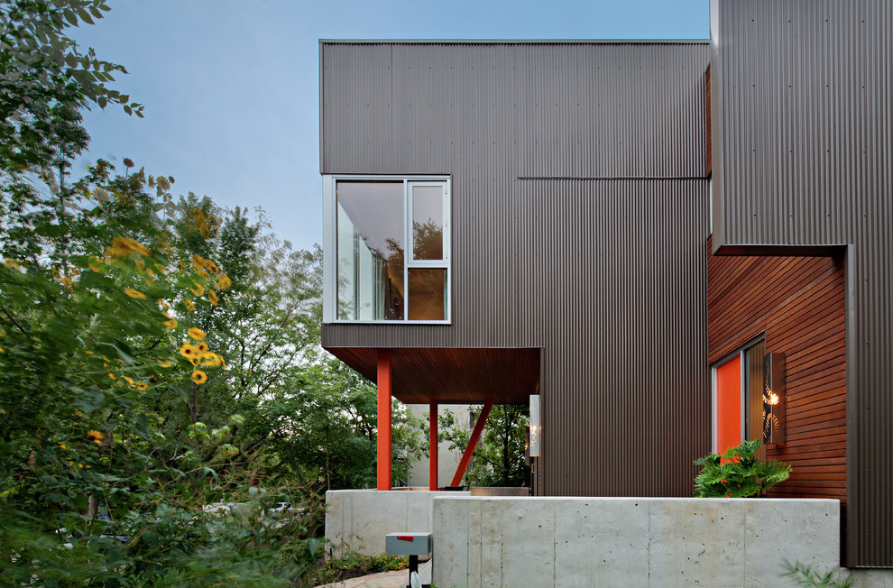 Inspiration for a modern house exterior in Kansas City with metal cladding.