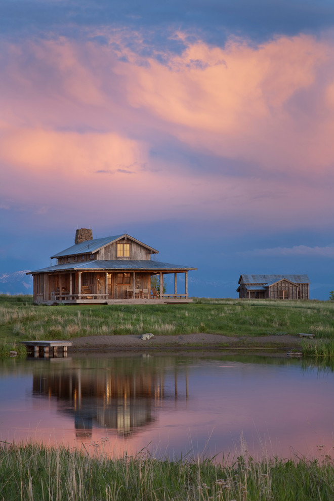Inspiration for a small rustic two-story wood gable roof remodel in Other