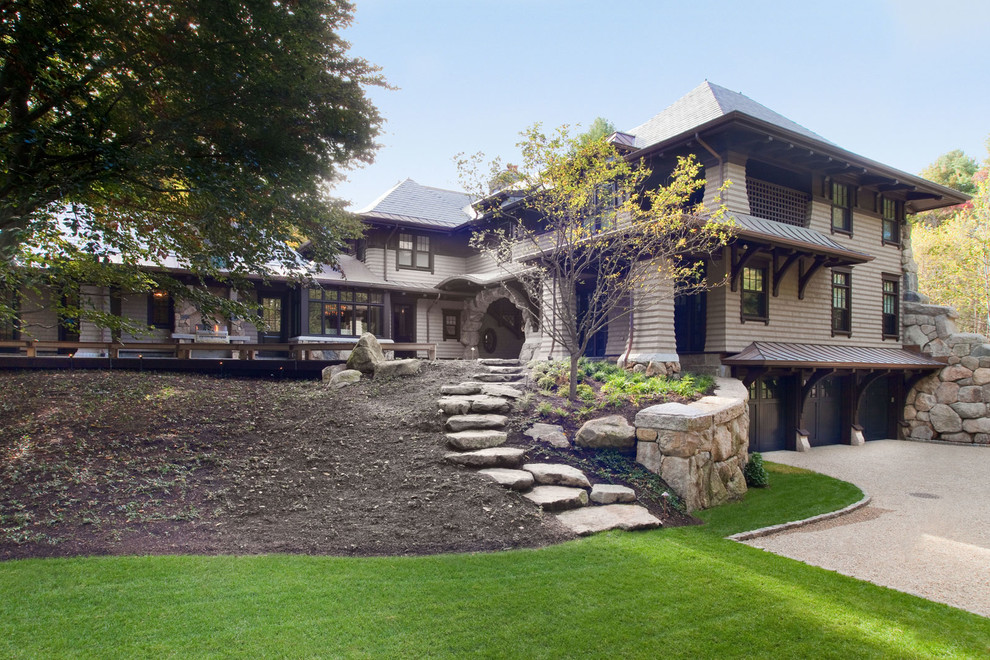 На фото: огромный, трехэтажный, коричневый дом в классическом стиле с облицовкой из камня