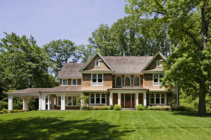 Example of an ornate wood exterior home design in New York