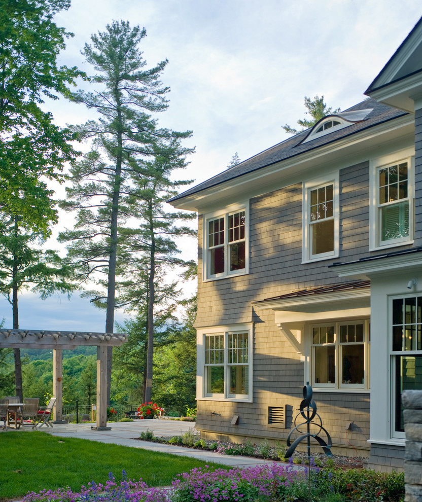 Inspiration for a large and gey victorian two floor house exterior in Burlington with wood cladding.