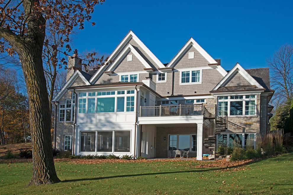 Large transitional gray three-story mixed siding exterior home photo in Minneapolis with a shingle roof