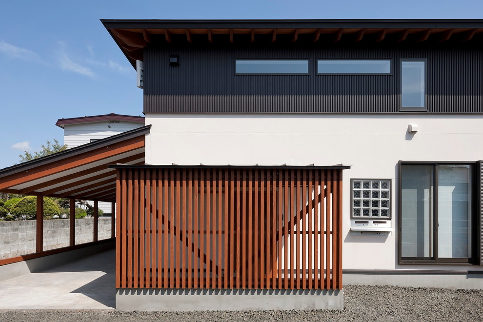 Modelo de fachada asiática de dos plantas con revestimientos combinados y tejado plano