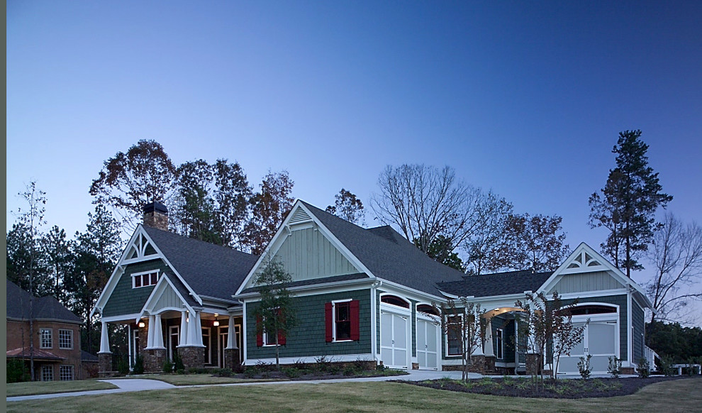 Example of a mid-sized arts and crafts blue two-story mixed siding exterior home design in Atlanta with a shingle roof