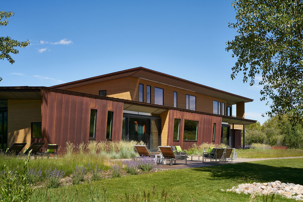 Großes, Zweistöckiges Modernes Einfamilienhaus mit Mix-Fassade, bunter Fassadenfarbe, Flachdach und Blechdach in Sonstige