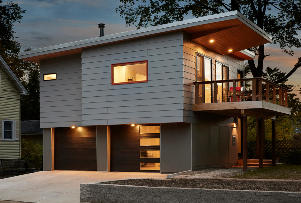 Foto della facciata di una casa piccola moderna con rivestimento in metallo e tetto piano
