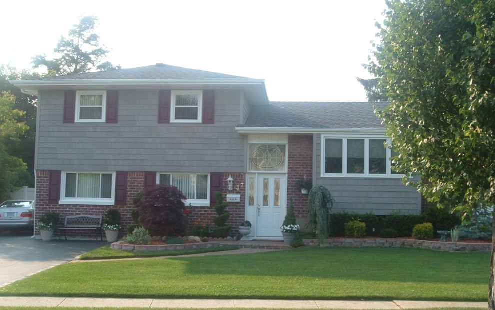 Inspiration for a mid-sized gray two-story exterior home remodel in New York