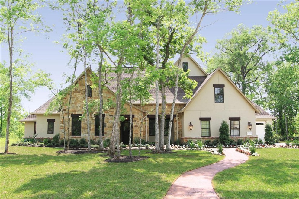 Inspiration for a large timeless beige two-story exterior home remodel in Houston