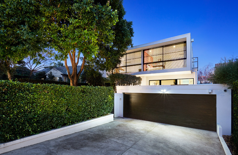 Design ideas for a white modern two floor house exterior in Melbourne with a flat roof.