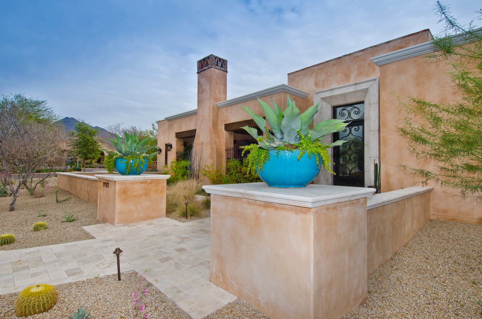 Inspiration for a mid-sized southwestern multicolored one-story adobe exterior home remodel in Phoenix