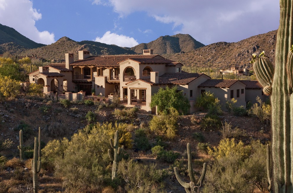 Large southwestern two-story stucco exterior home idea in Phoenix