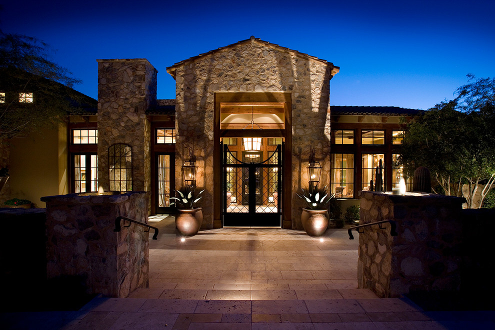 Photo of a mediterranean house exterior in Phoenix with stone cladding.