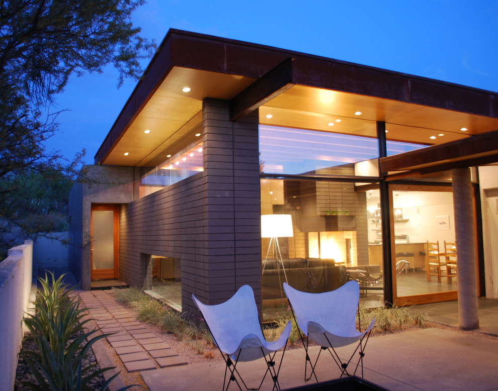 Свежая идея для дизайна: маленький, одноэтажный, серый дом в стиле модернизм с облицовкой из бетона для на участке и в саду, охотников - отличное фото интерьера